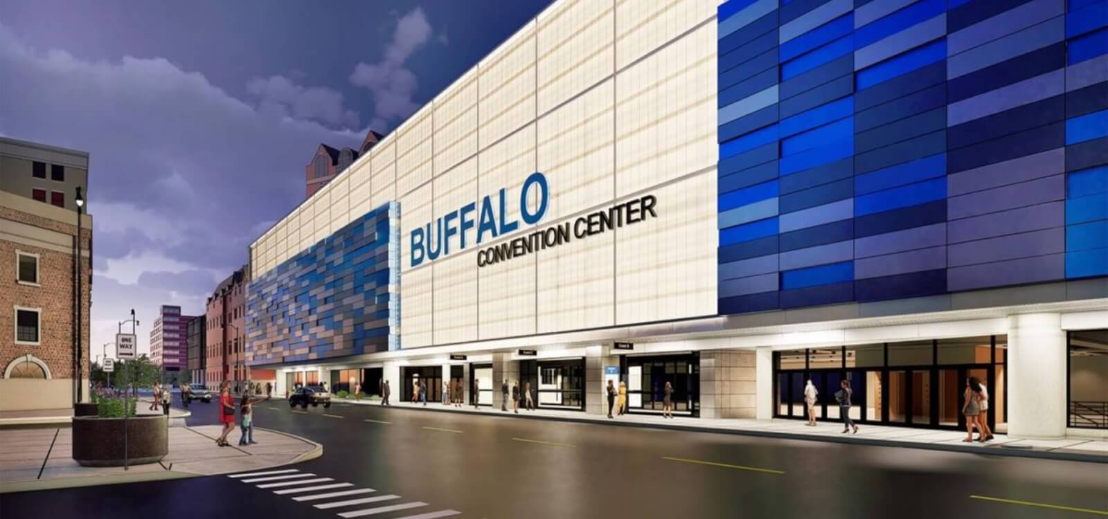 Pedestrians walk along the blue and white exterior of the Buffalo Convention Center in Buffalo, NY