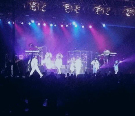 Musicians dressed in white suits perform on stage at the Buffalo Convention Center.