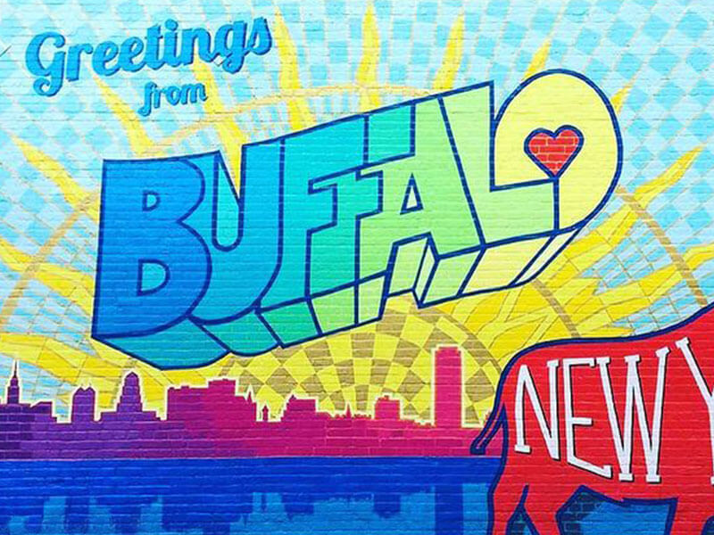 Greenting from Buffalo mural is painted in bright, primary colors.